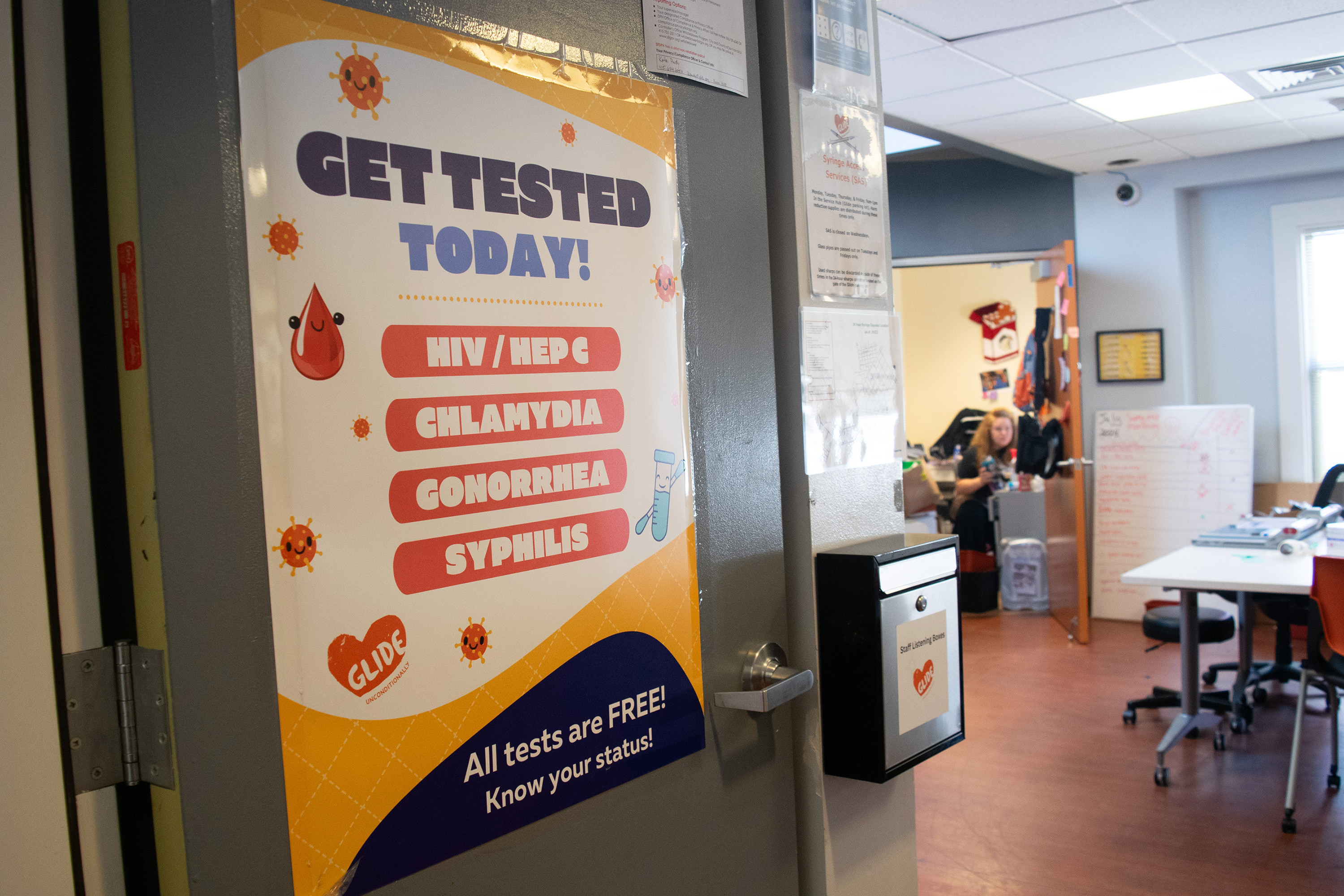 A photo of a sign on a door that reads, "Get tested today."