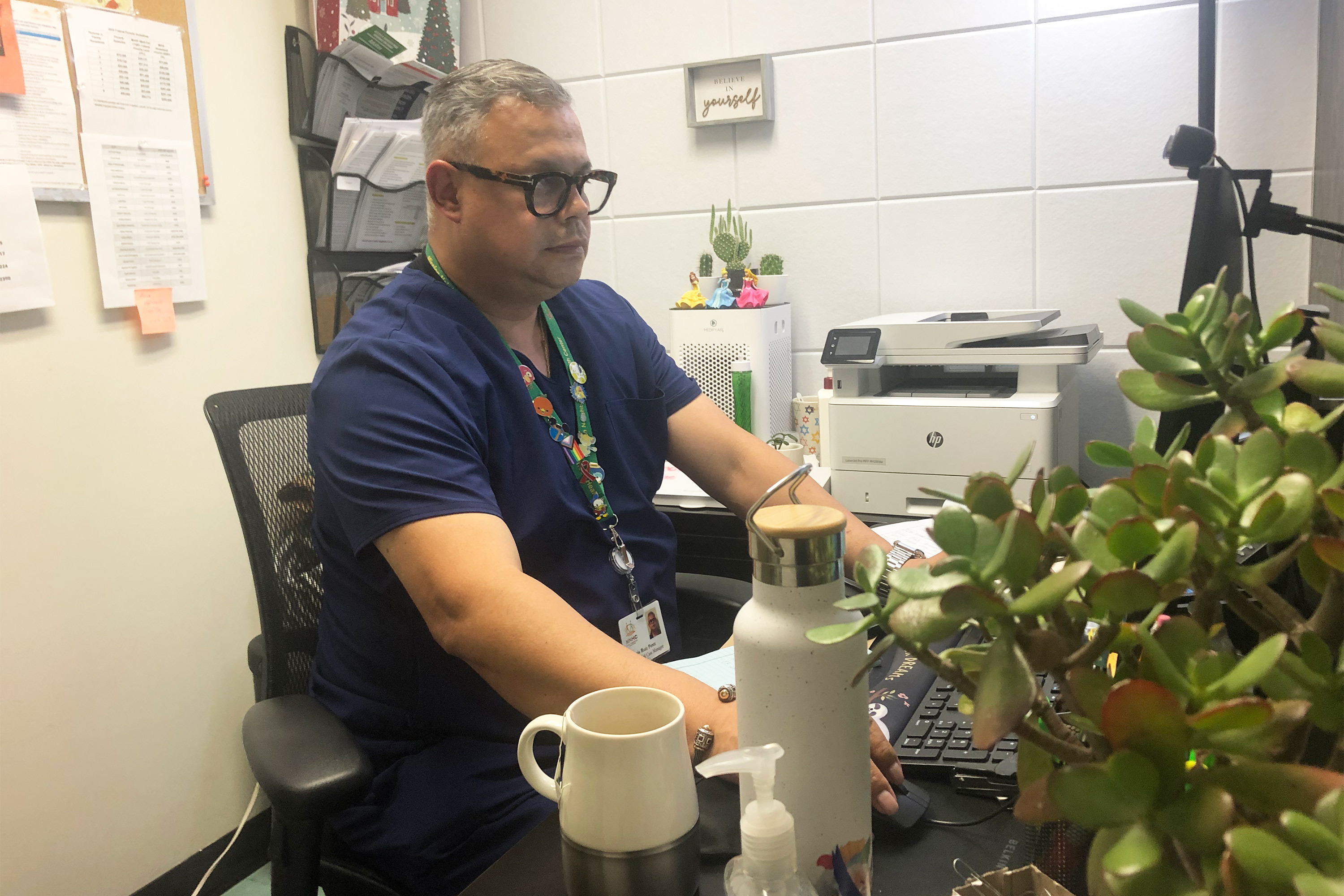 A photo of a man working at a computer.