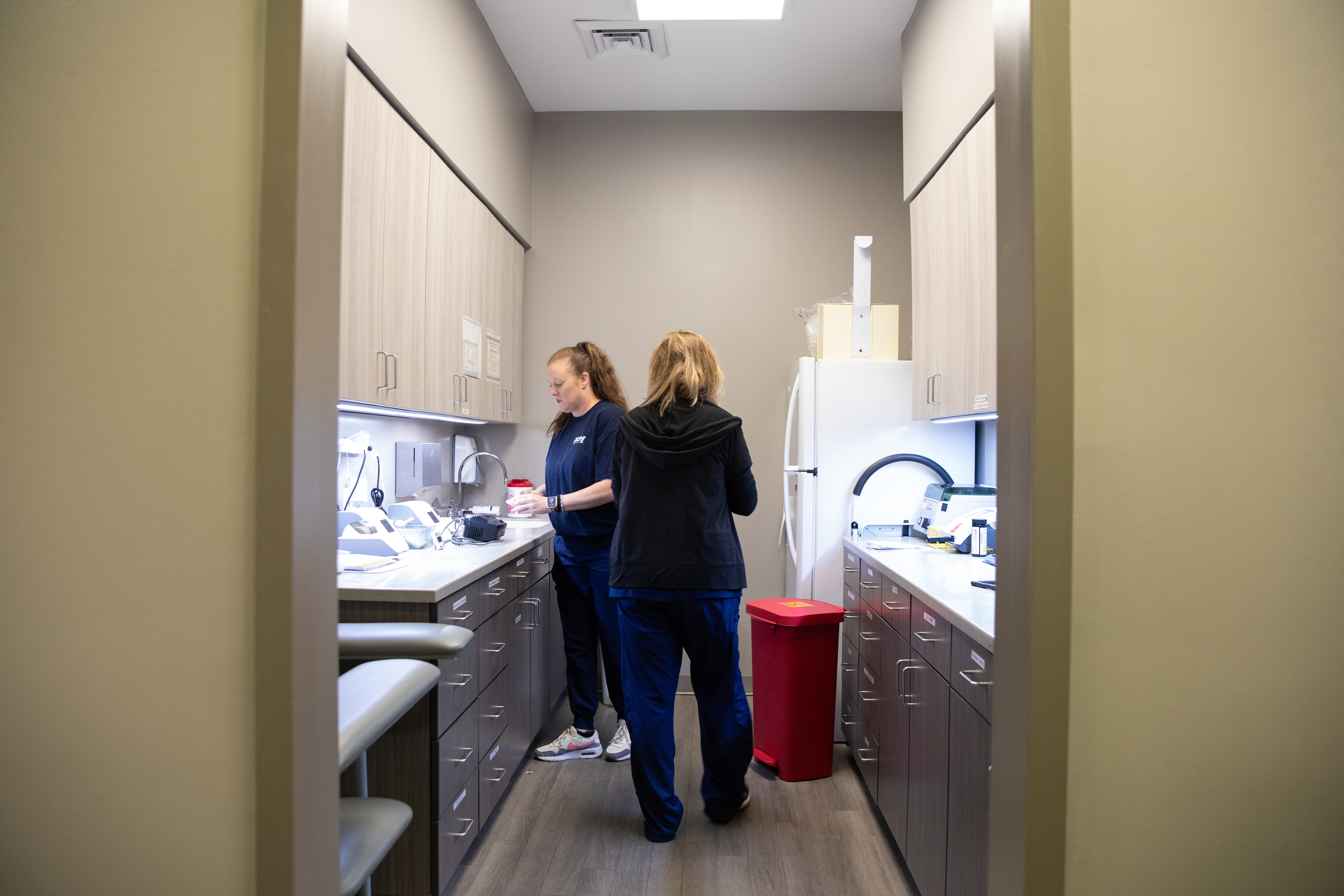 Two medical professionals inside a health clinic