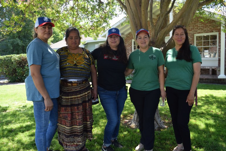 Four women stand side by side