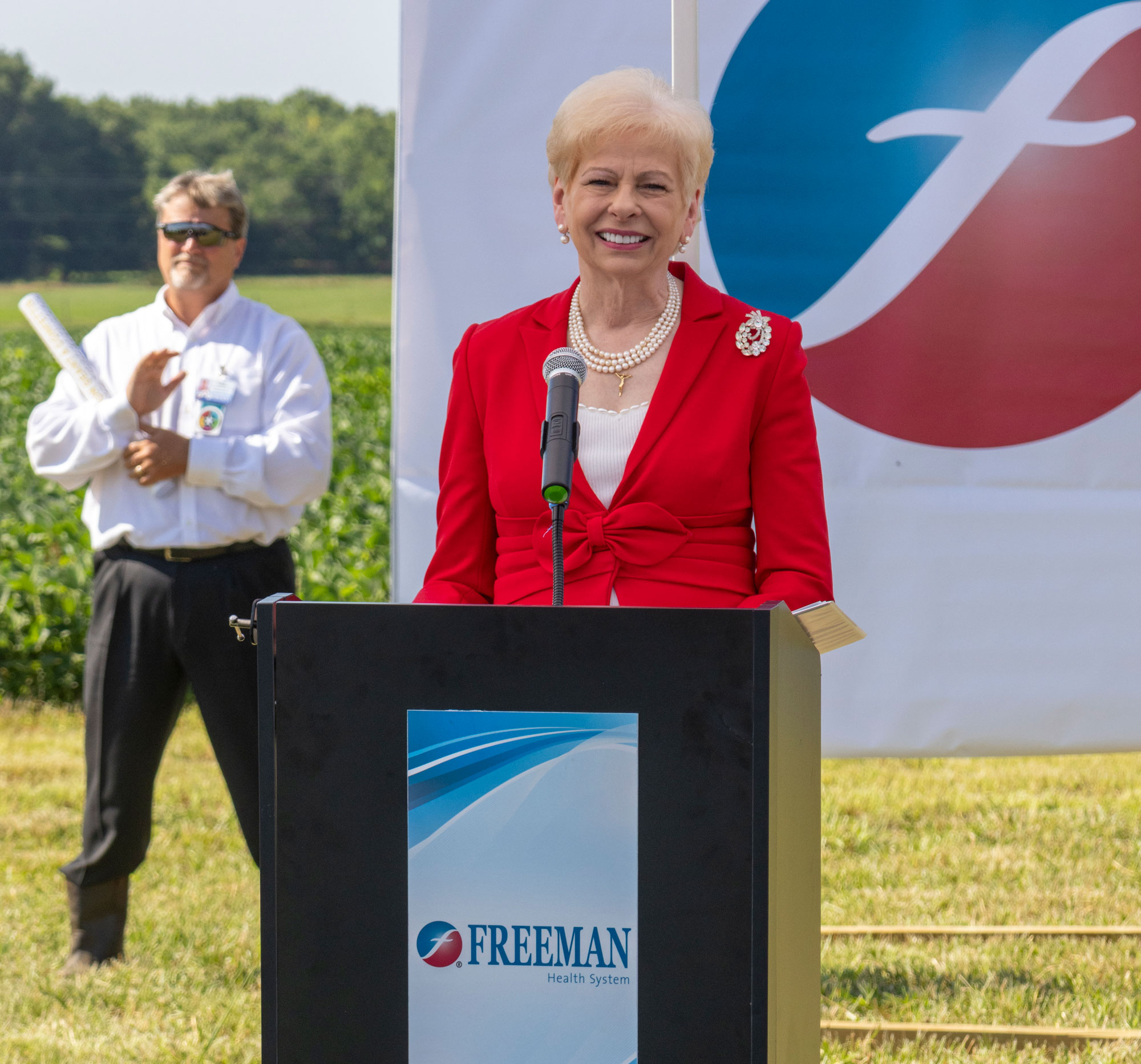 A photo of Paula Baker speaking at a podium.