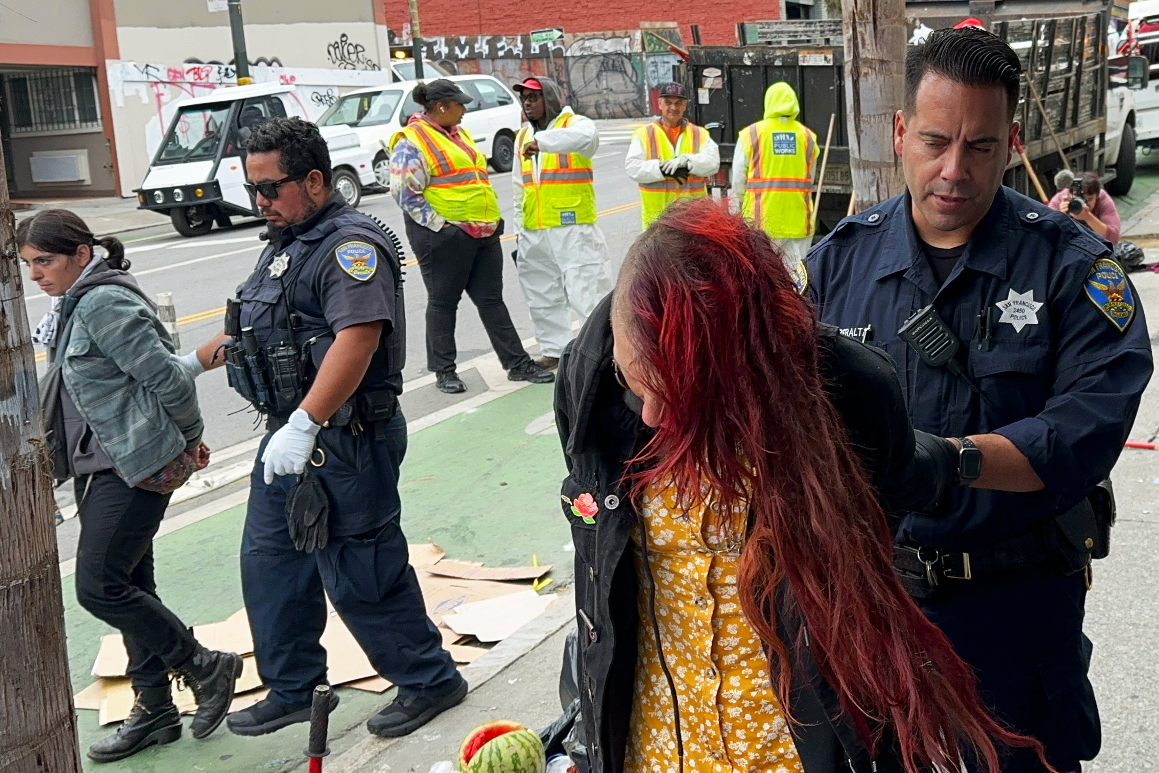 Health and Medical news A photo of two homeless people being handcuffed.