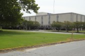 A large lawn with a hospital building in the background