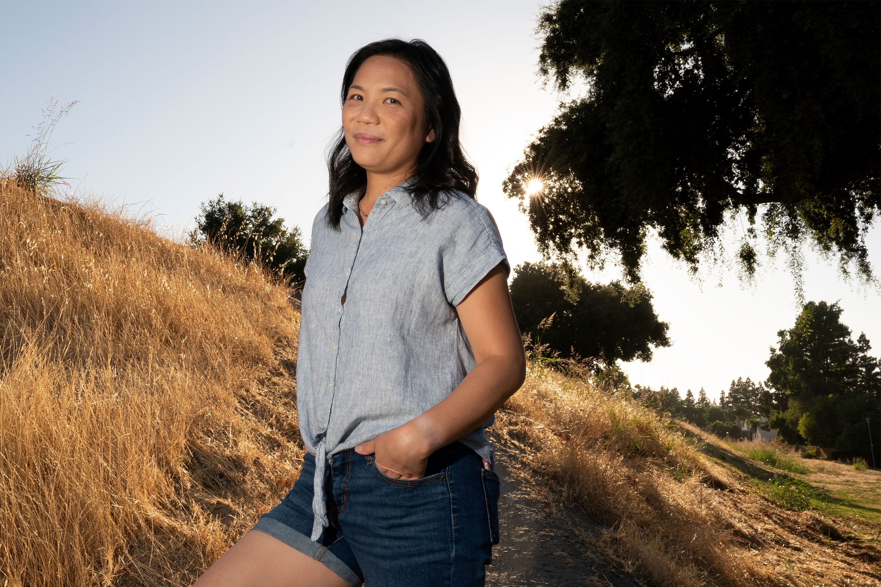 A photo of Christina Kashiwada standing outside at a park near her home.