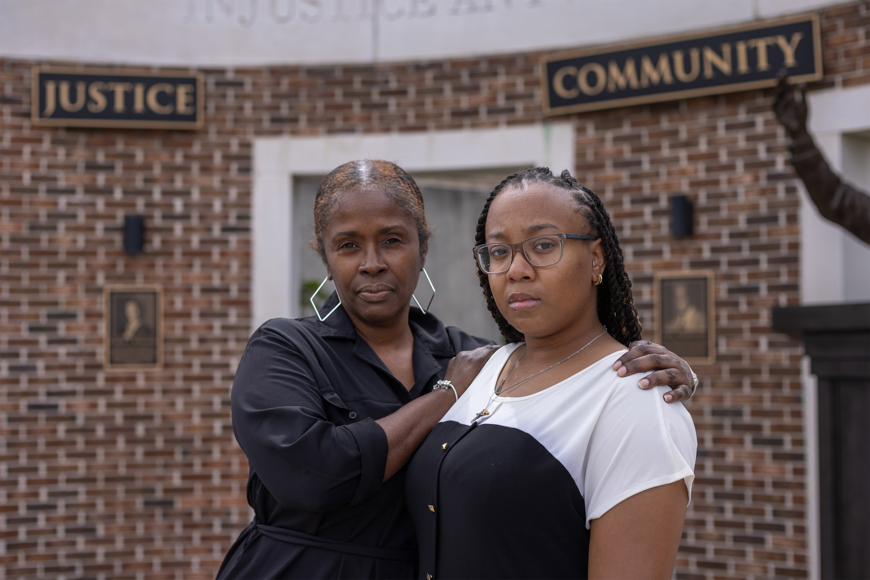 A photo of Zipporah Sumpter with her arms around Amari Marsh's shoulders. Both are looking at the camera.