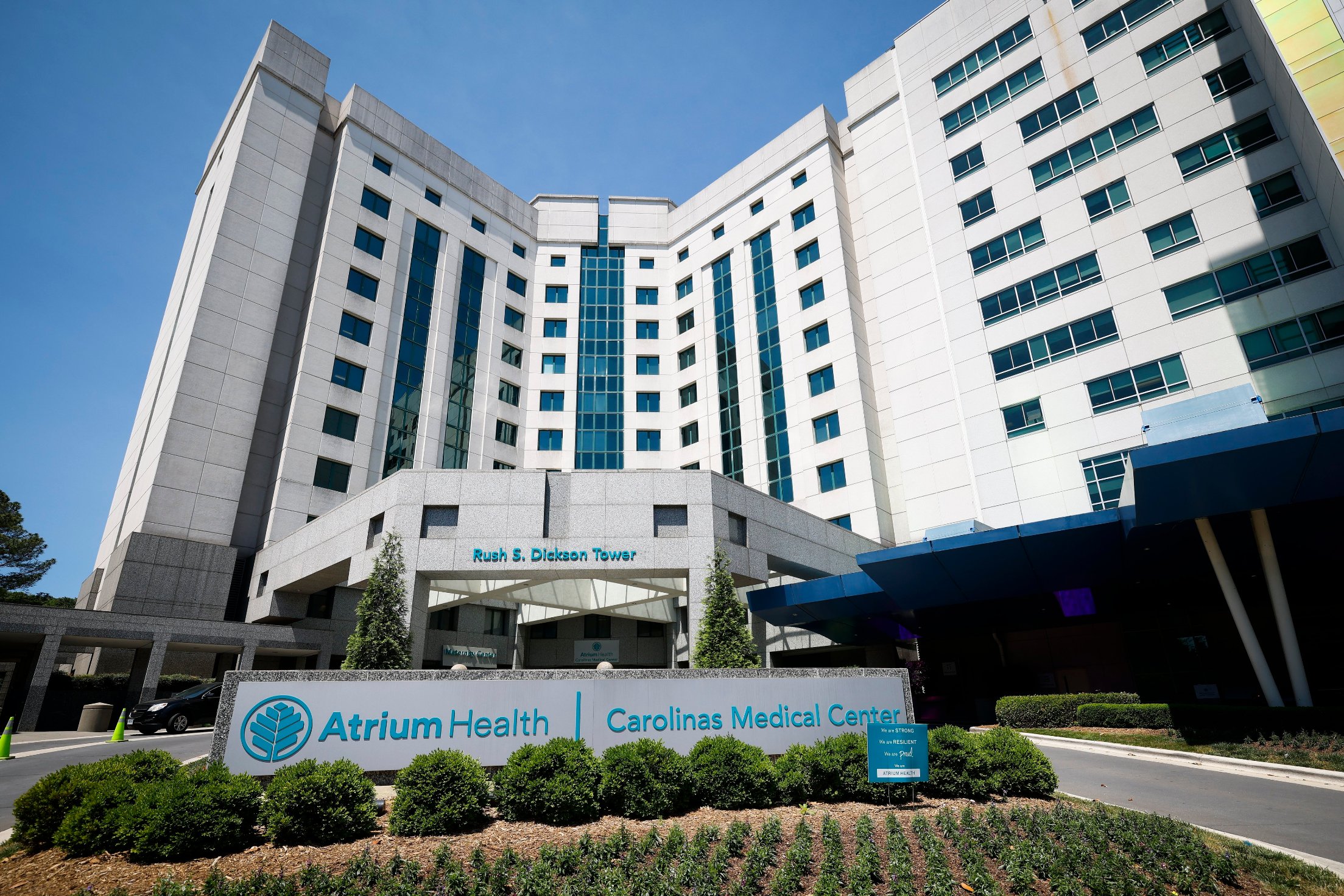 An exterior photograph of the Carolinas Medical Center on a bright sunny day.