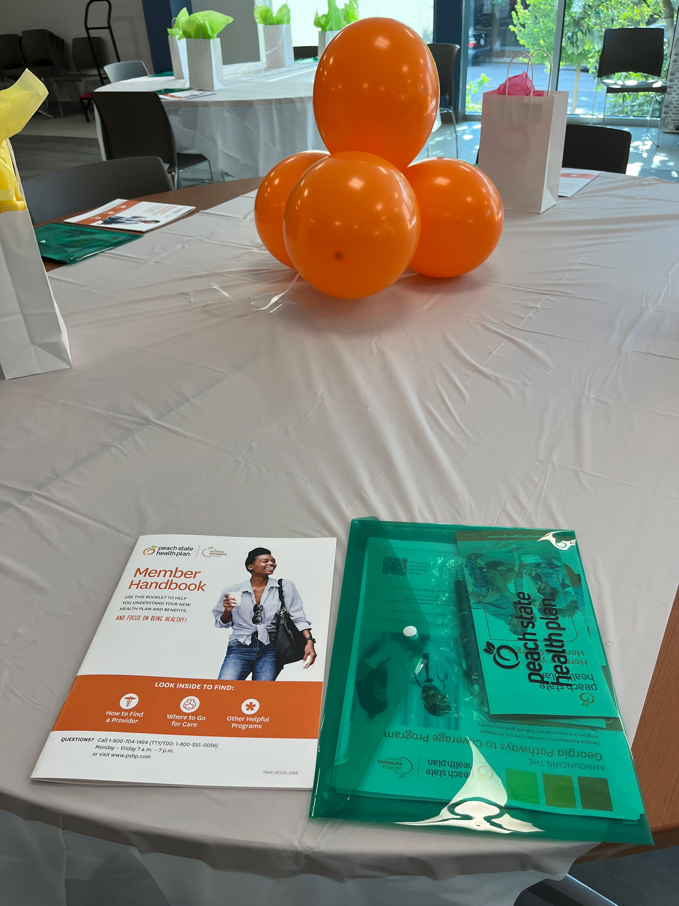 Health and Medical news A photo of a table with orange balloons and pamplets.