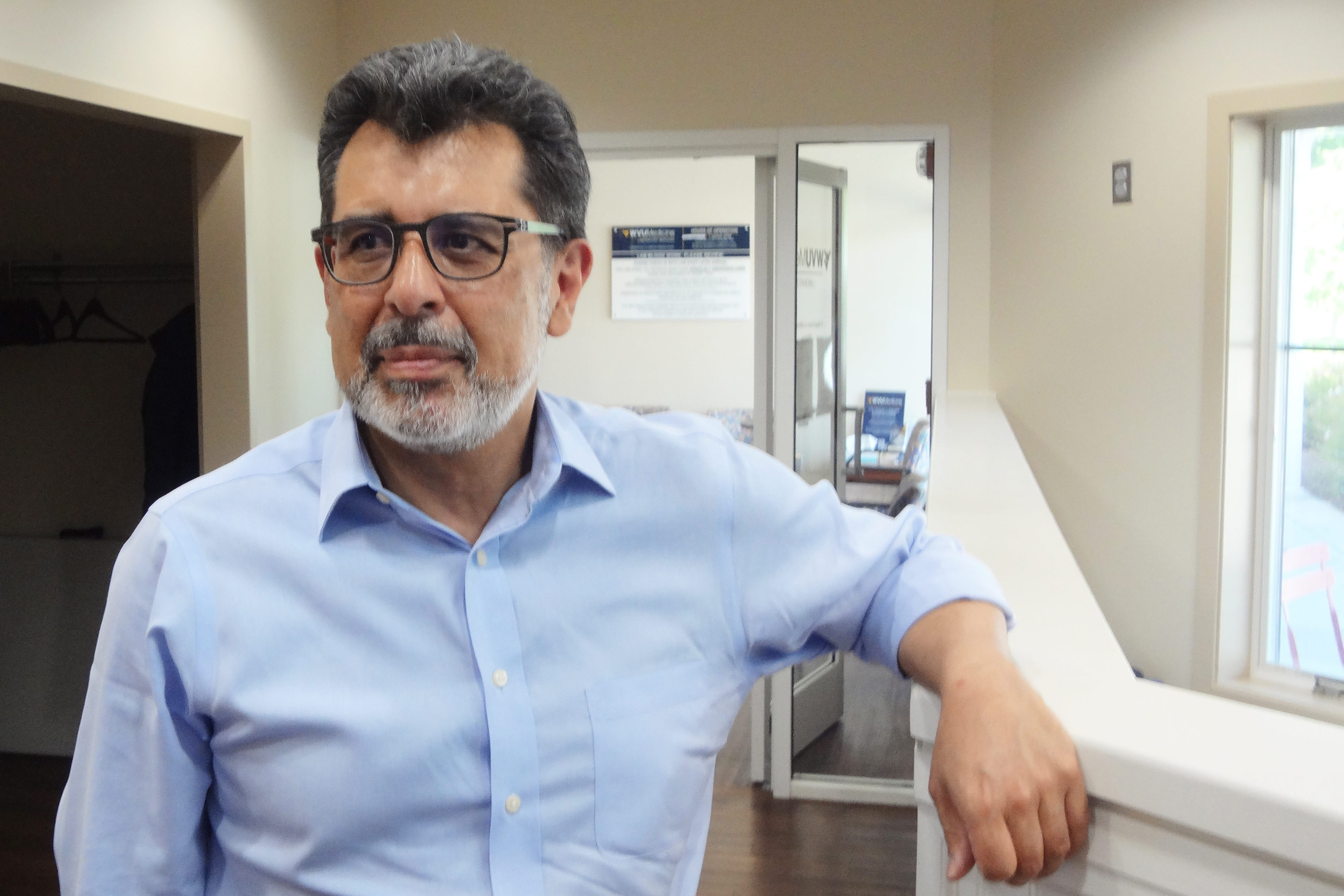 A portrait of David Baltierra, a man with a short gray beard and glasses.