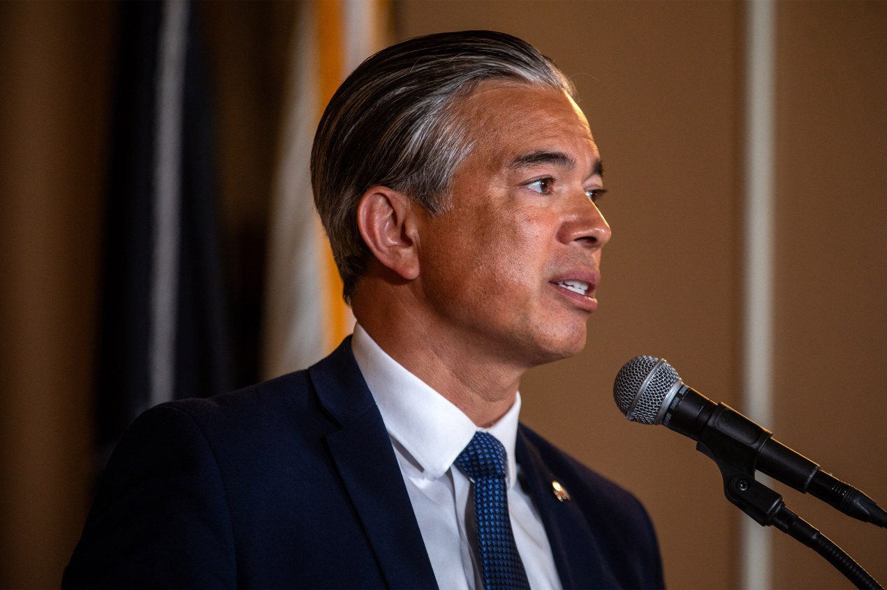 A photo of Rob Bonta speaking into a microphone.