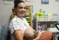 A portrait of Cailyn Morreale holding her infant in her arms.