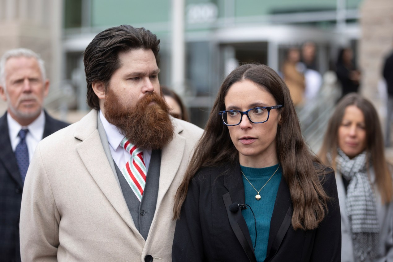 A photo of Jennifer Adkins standing outside of a courthouse.