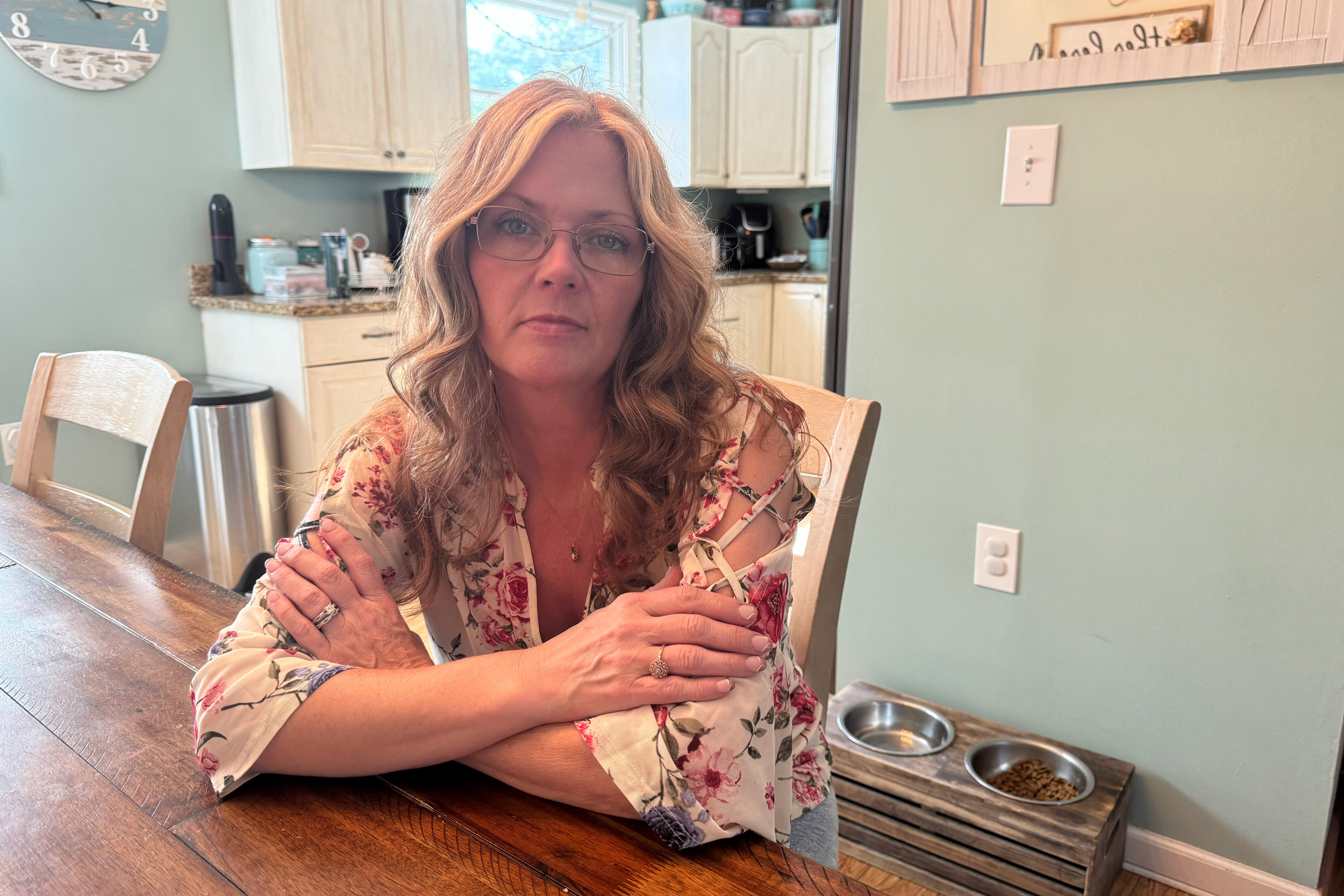 A photo of a woman sitting at a table.