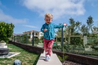 A photo of a toddler running in his backyard.