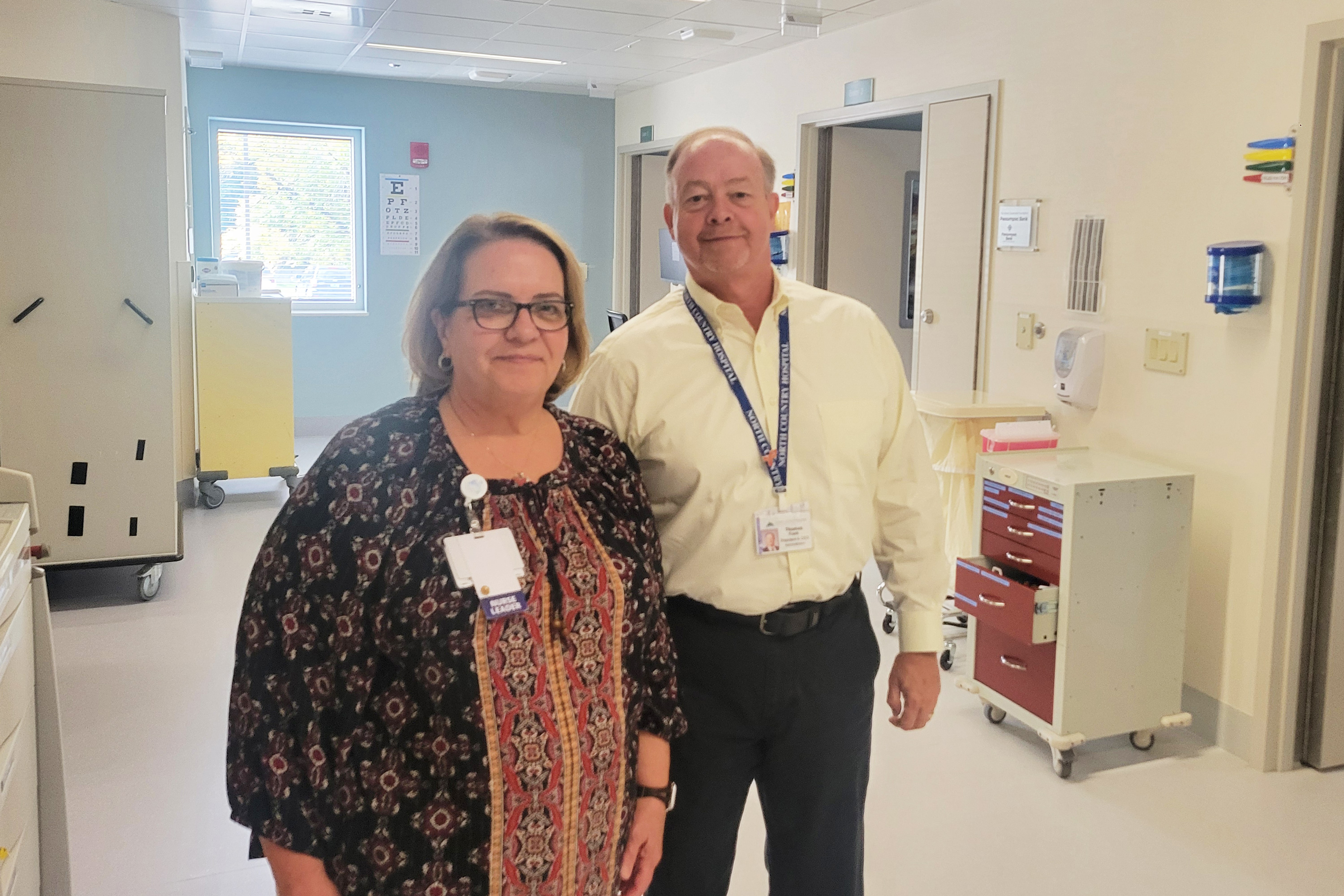 A photo of a woman and a man standing next to each other in a hospital.