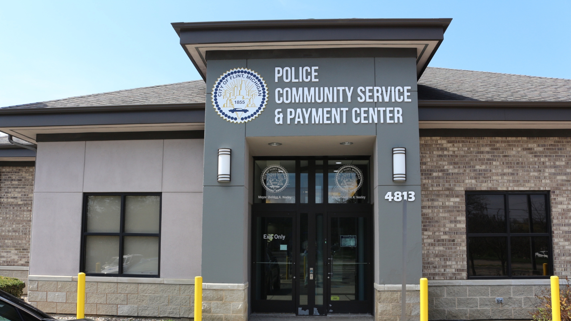 The sign above a building entrance reads "Police Community Service & Payment Center".