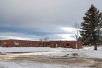 A photo of the exterior of a behavioral health center. Snow covers the ground around it.