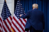 A photograph of the back of President-elect Donald Trump as he walks away from the camera.