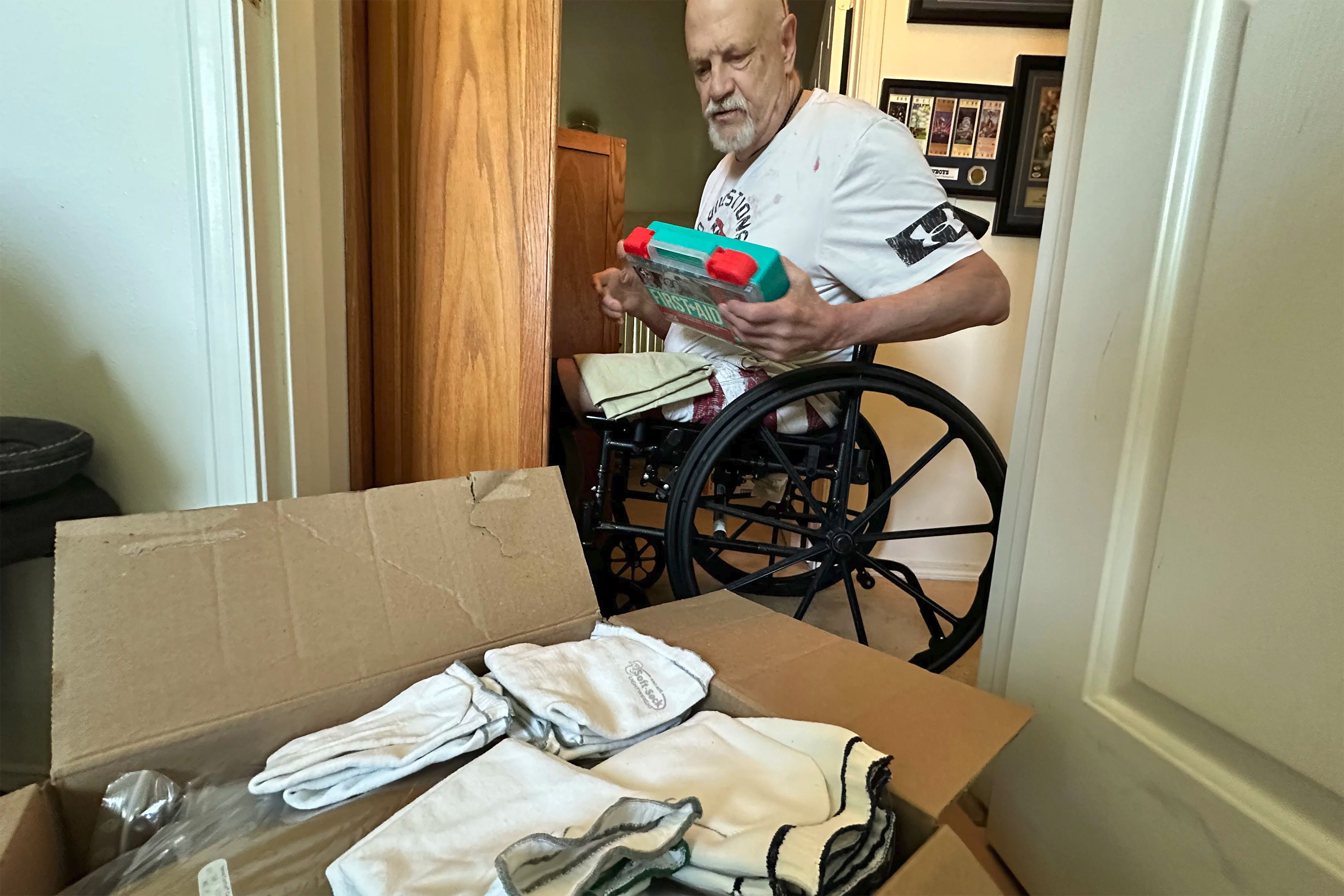 A photo of Kim Hilton packing up his belongings in boxes.