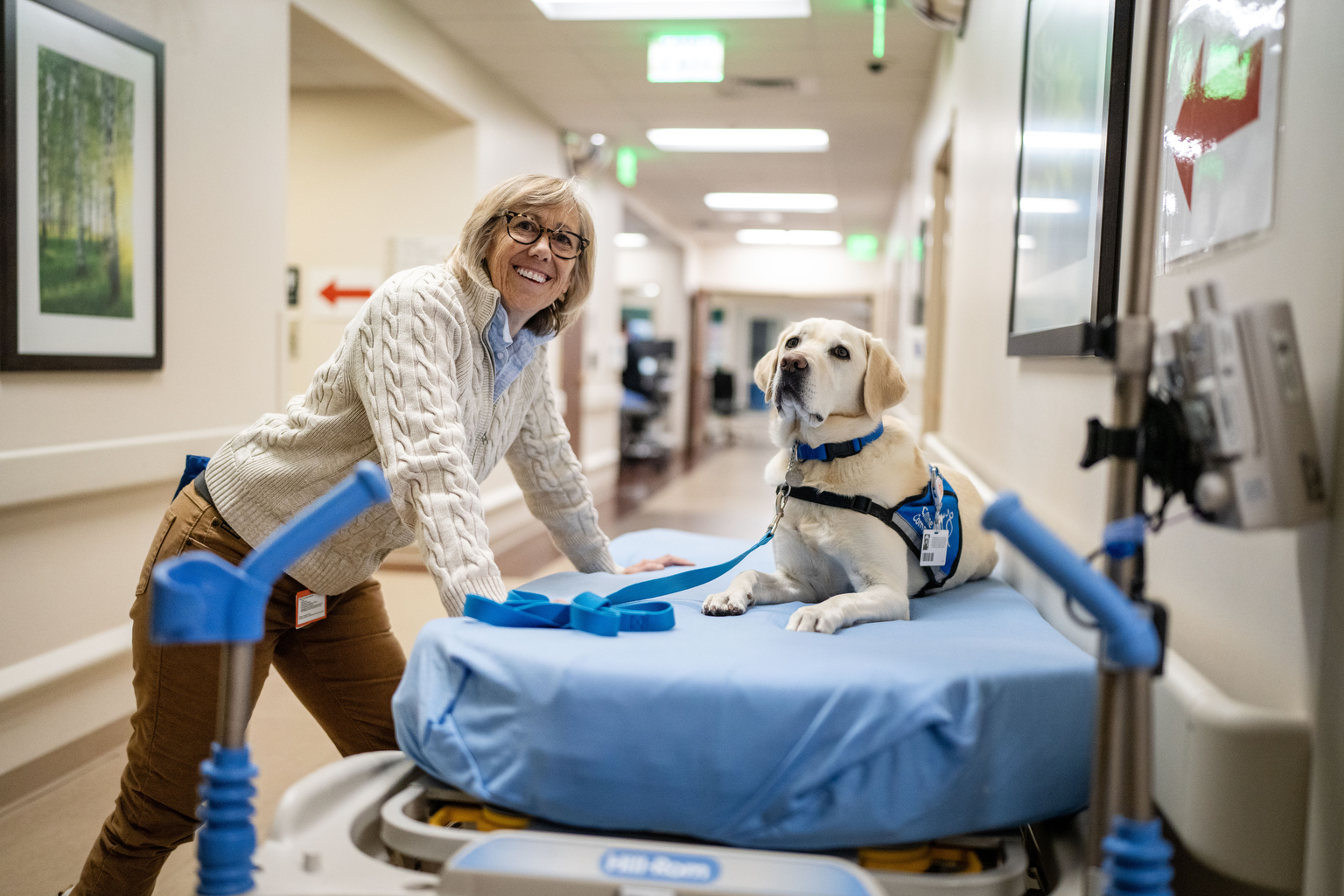 A photo of a physician posing for a photo with her dog, Peppi.