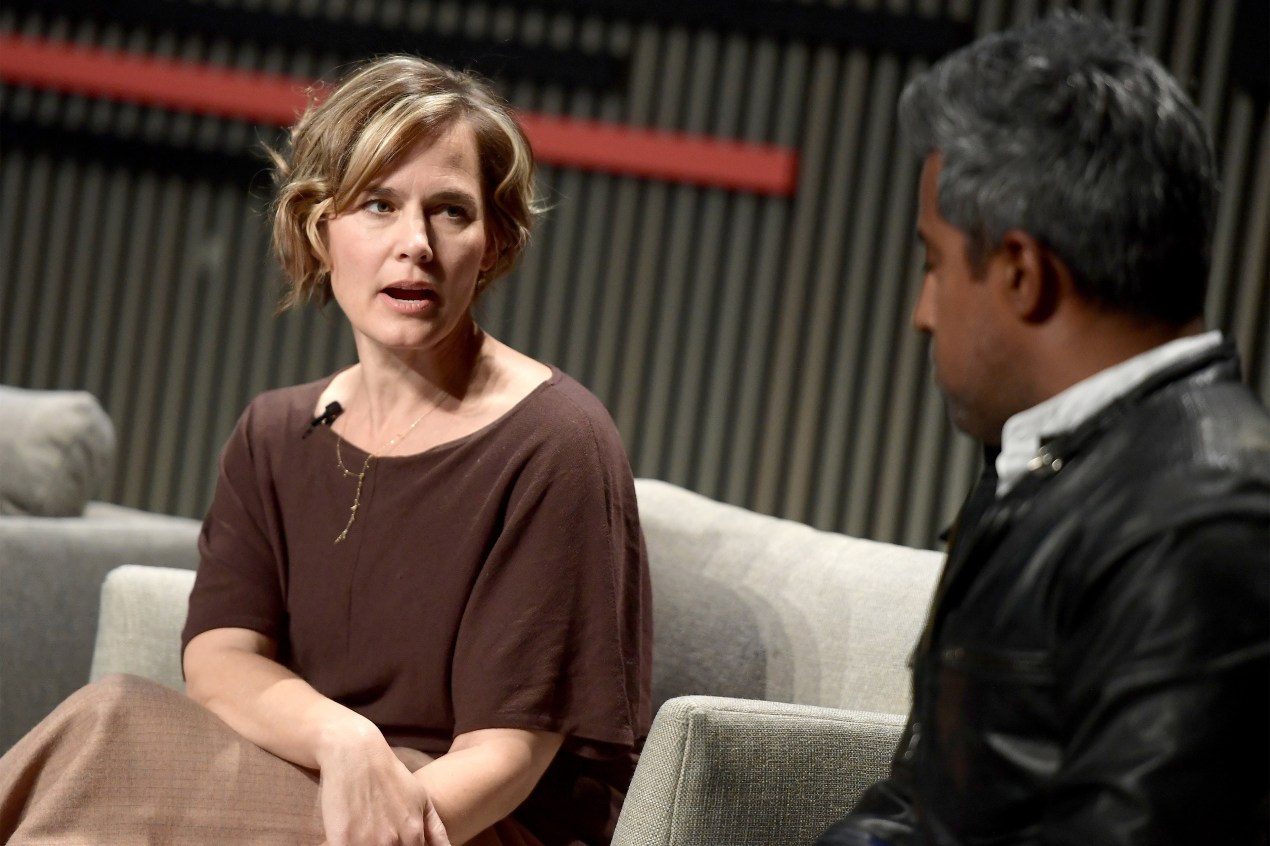 A photo of Jennifer Pahlka speaking to Anand Giridharadas onstage at a conference.