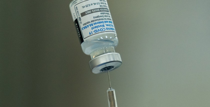 A close-up photo of a syringe inserted into a vial.