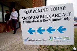 An Affordable Care Act application and enrollment help sign outside of a building.