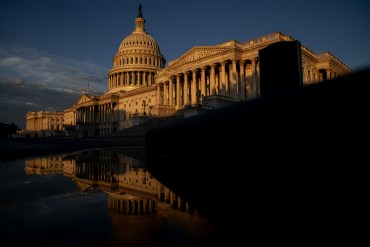 A photo of the US Capitol building at sunrise.