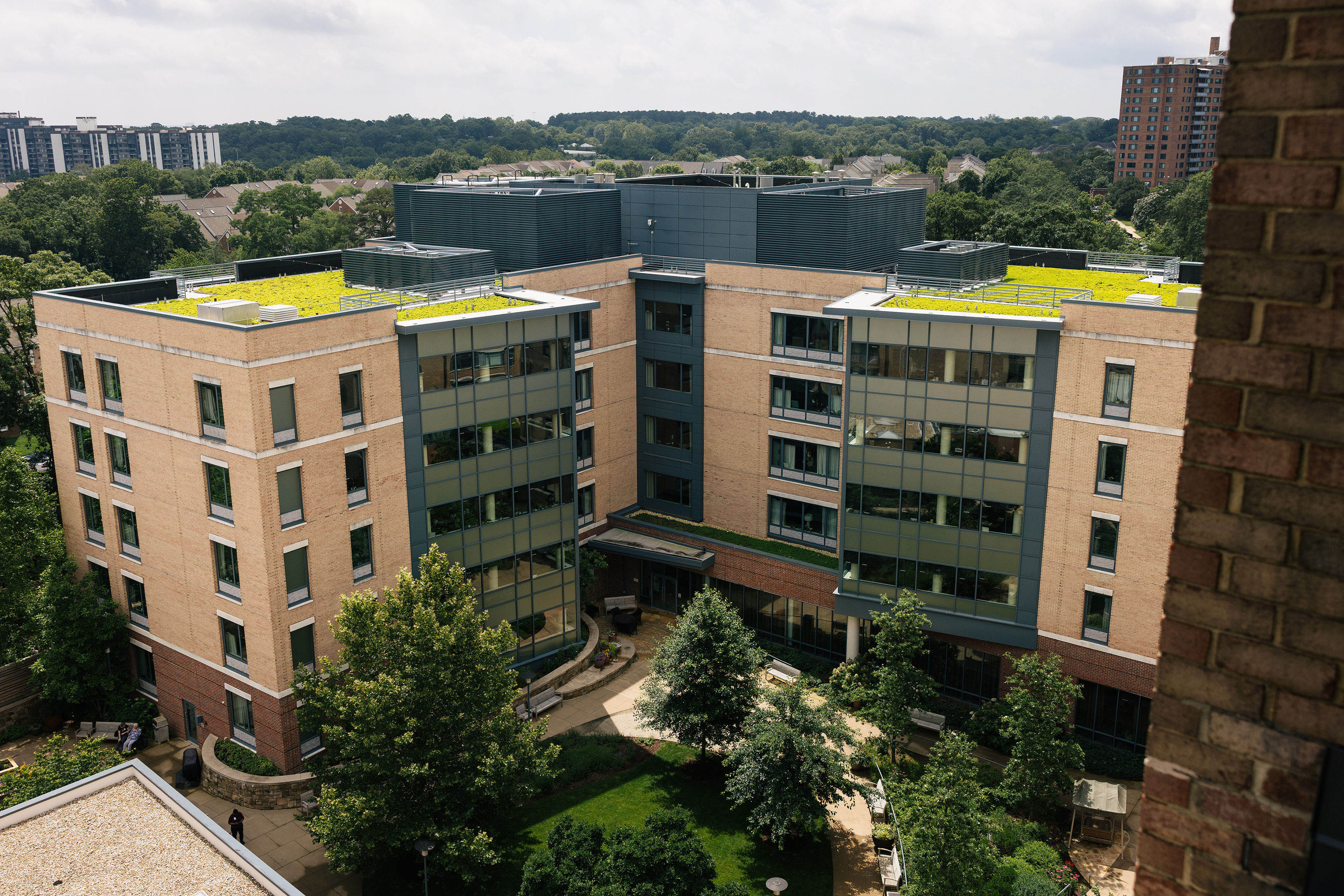 An arial shot of a 5-story modern nursing home building.