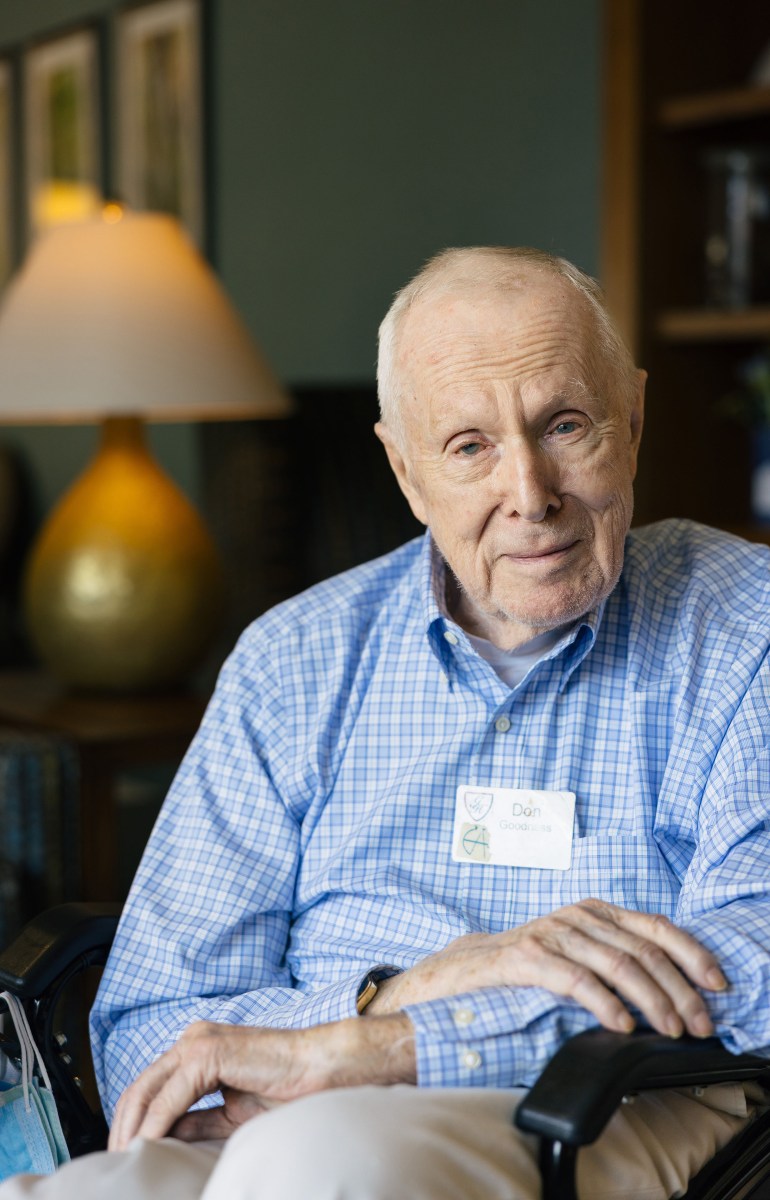 A portrait of a senior man with a gentle smile.