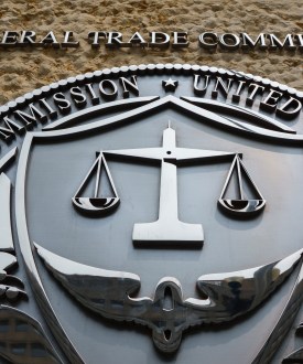 A photo of the Federal Trade Commission's logo on the outside of a building.