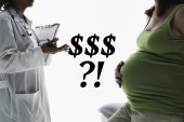 A photo of an unidentifiable doctor and pregnant patient facing one another in conversation.