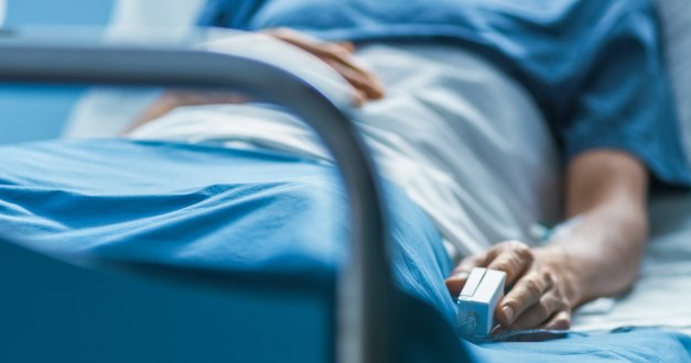 A patient lying in a hospital bed.