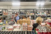 A man sorts through a food delivery at a food bank