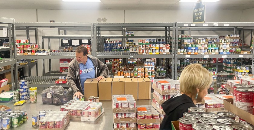 A man sorts through a food delivery at a food bank