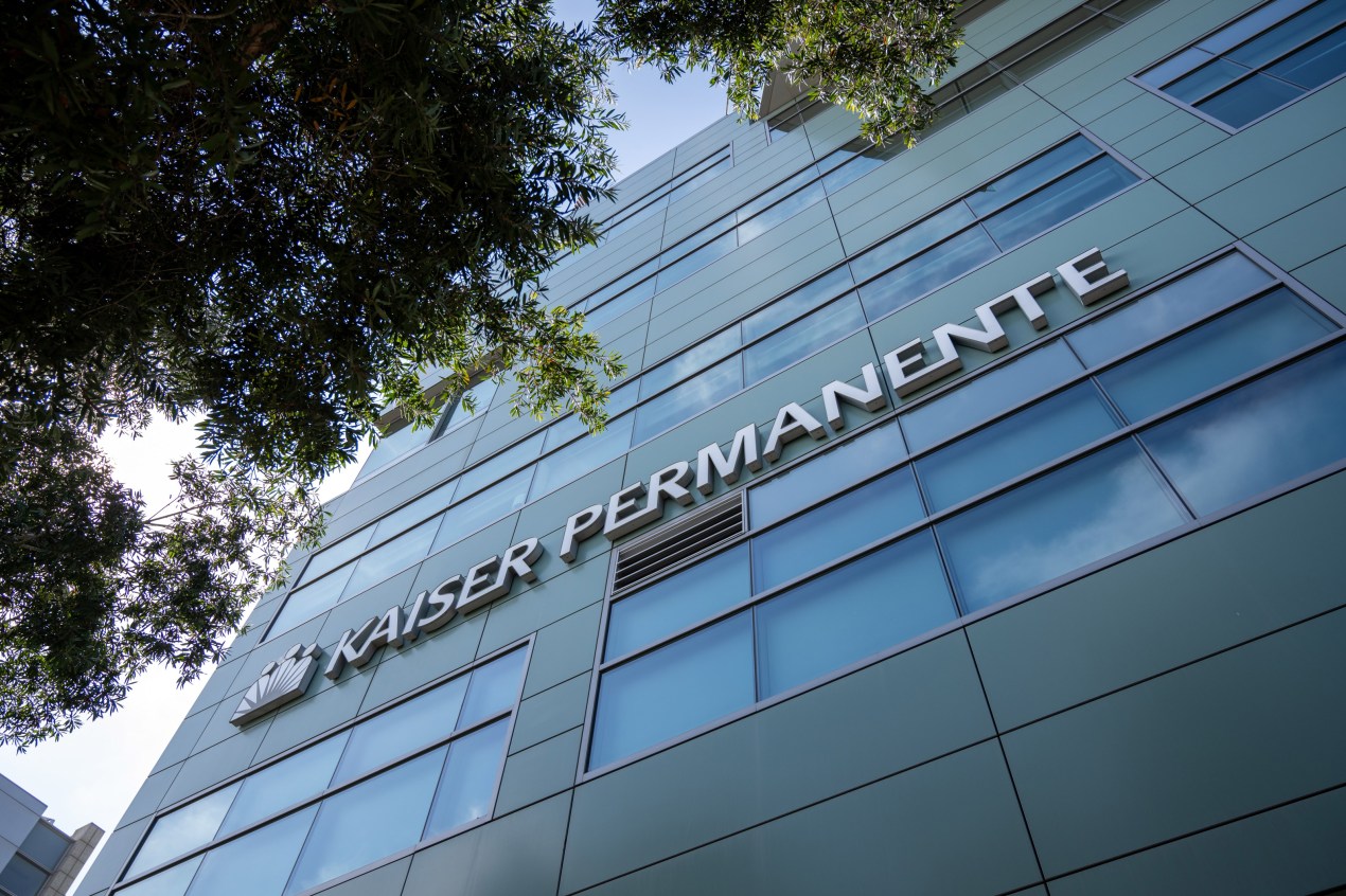 A photo of the Kaiser Permanente logo on the facade of a building.