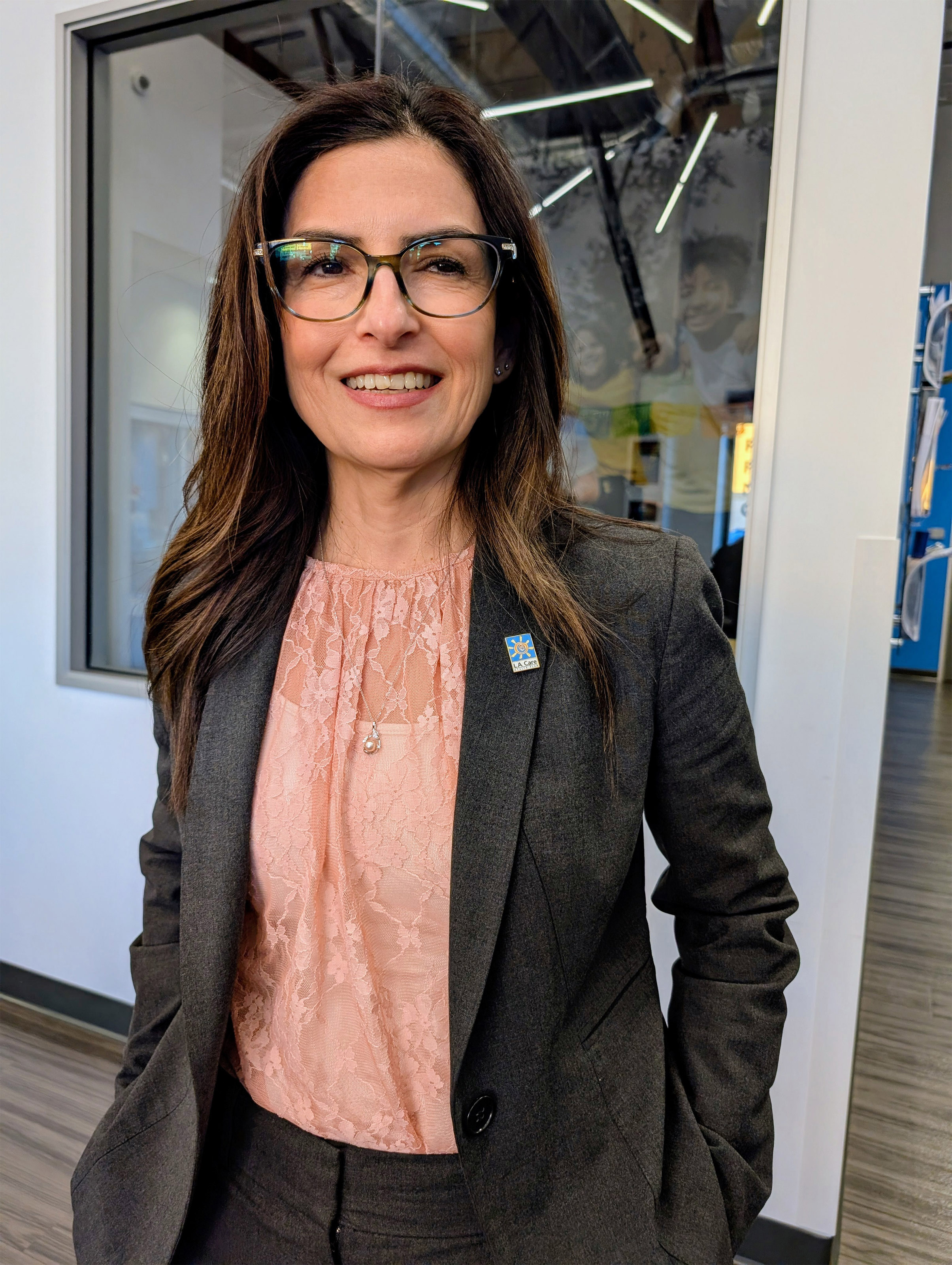 A photo shows Martha Santana-Chin standing indoors at the Lincoln Heights community center.