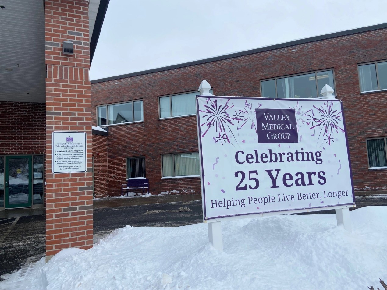 The exterior of a medical clinic with a sign reading "Celebrating 25 years"