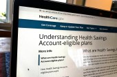 A photo of the healthcare.gov website on a laptop, which shows a page with information about HSAs.