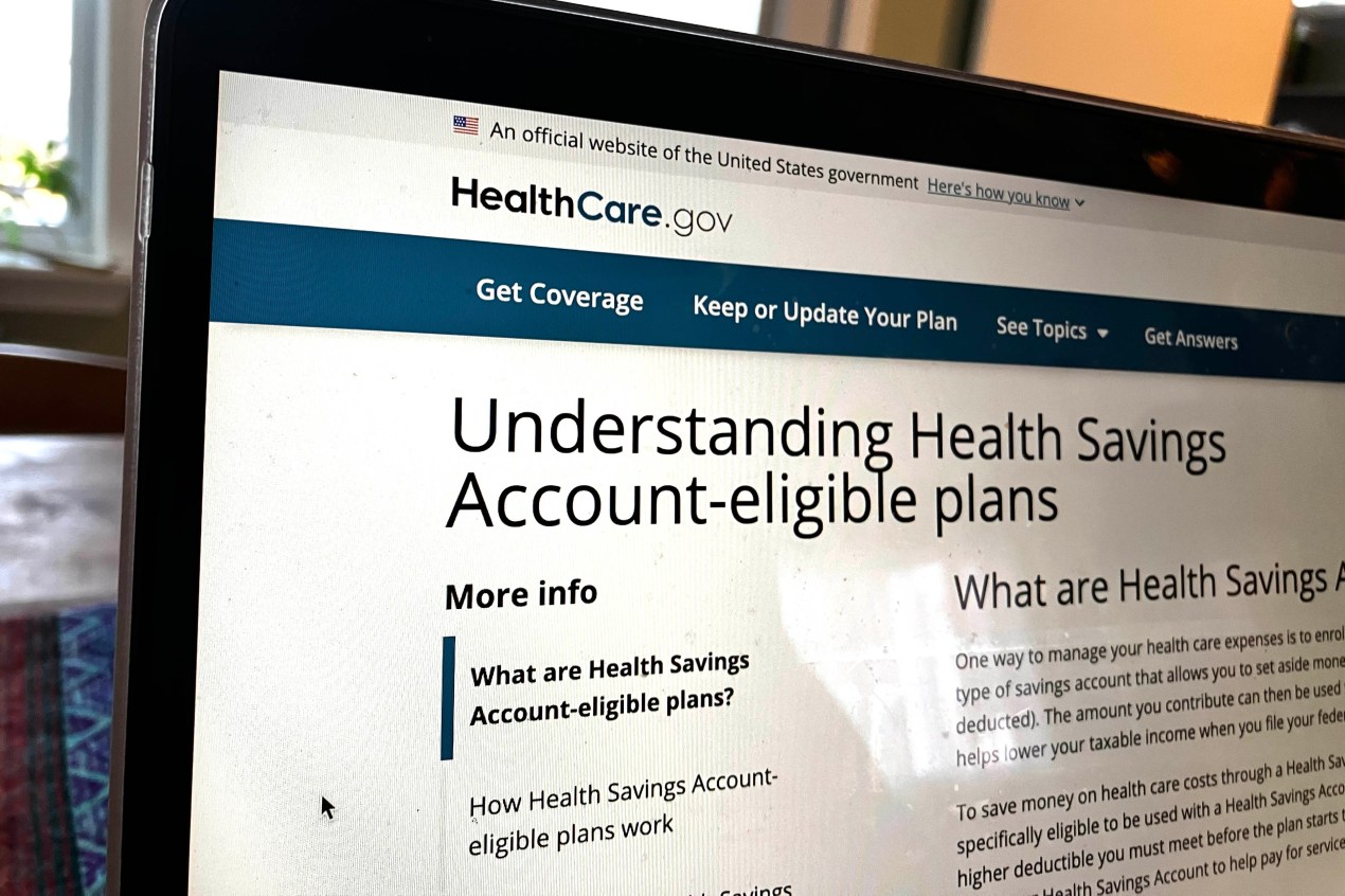 A photo of the healthcare.gov website on a laptop, which shows a page with information about HSAs.