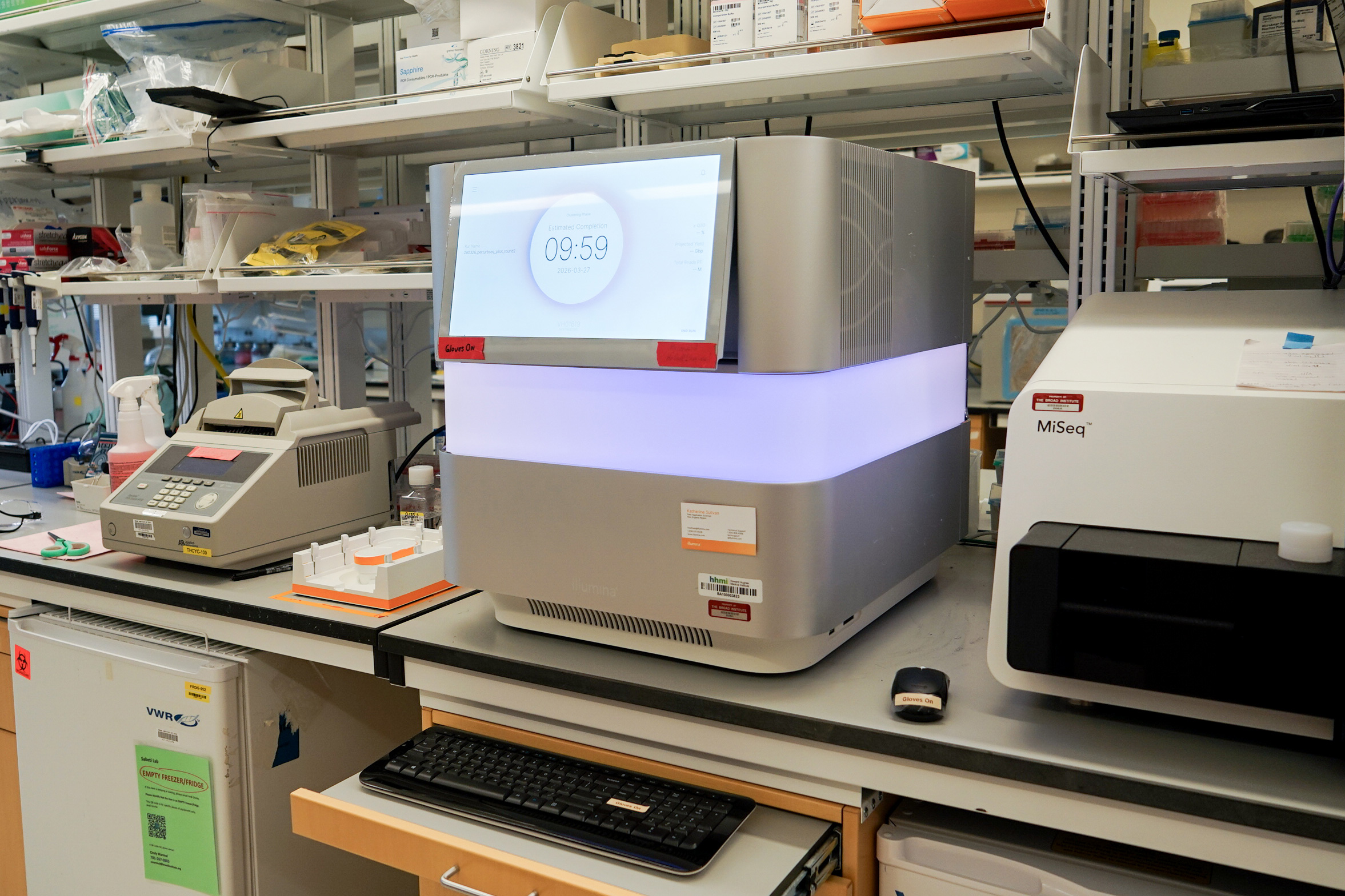 Three machines rest on a table at a laboratory.