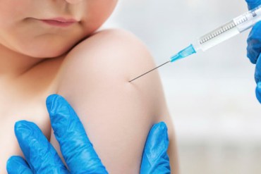 Boy and vaccine syringe