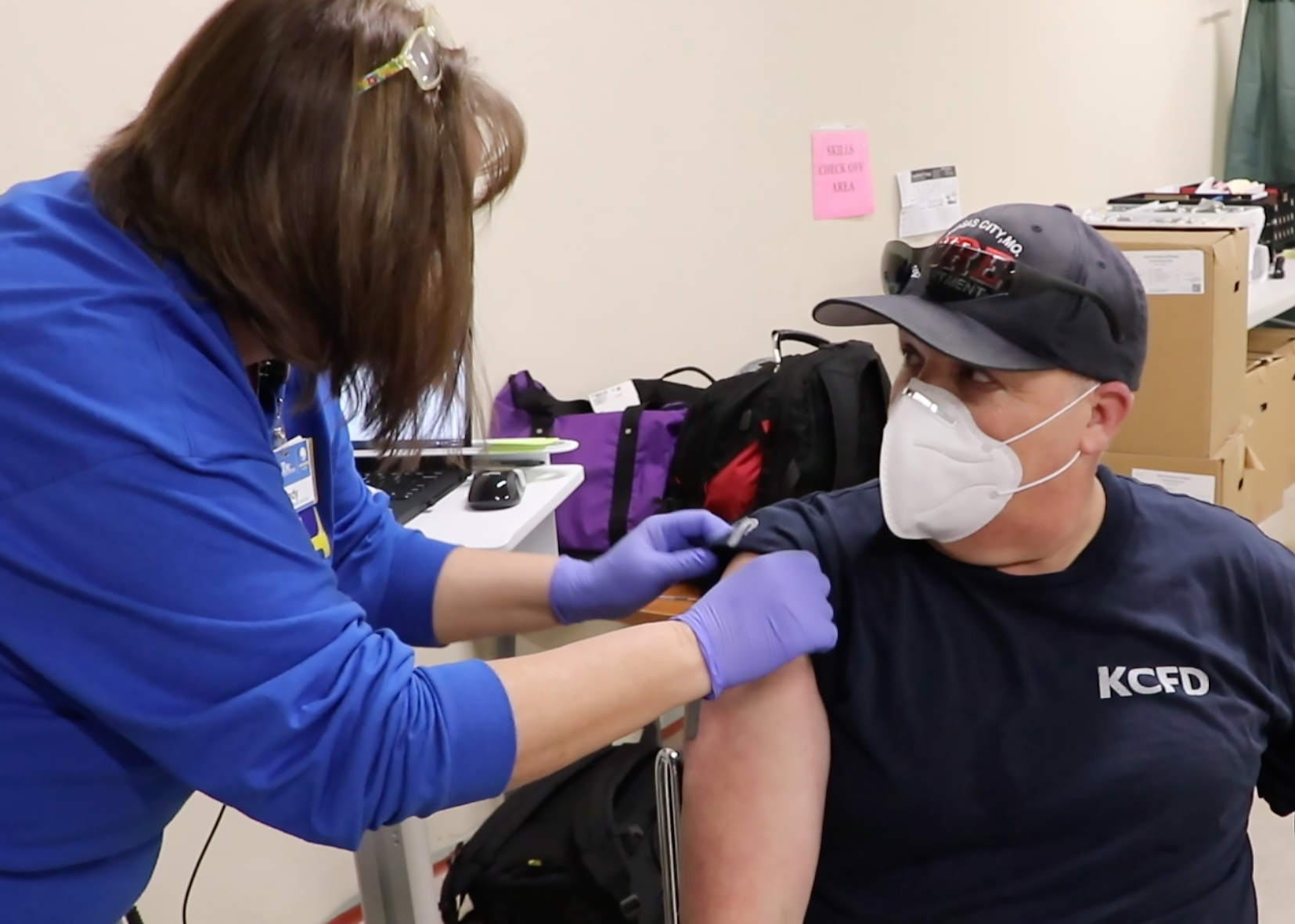 a man receives a covid-19 vaccine