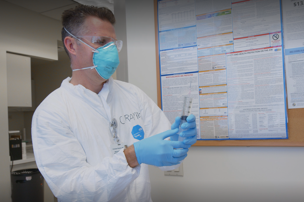 Dr. Christian Ramers holding a syringe