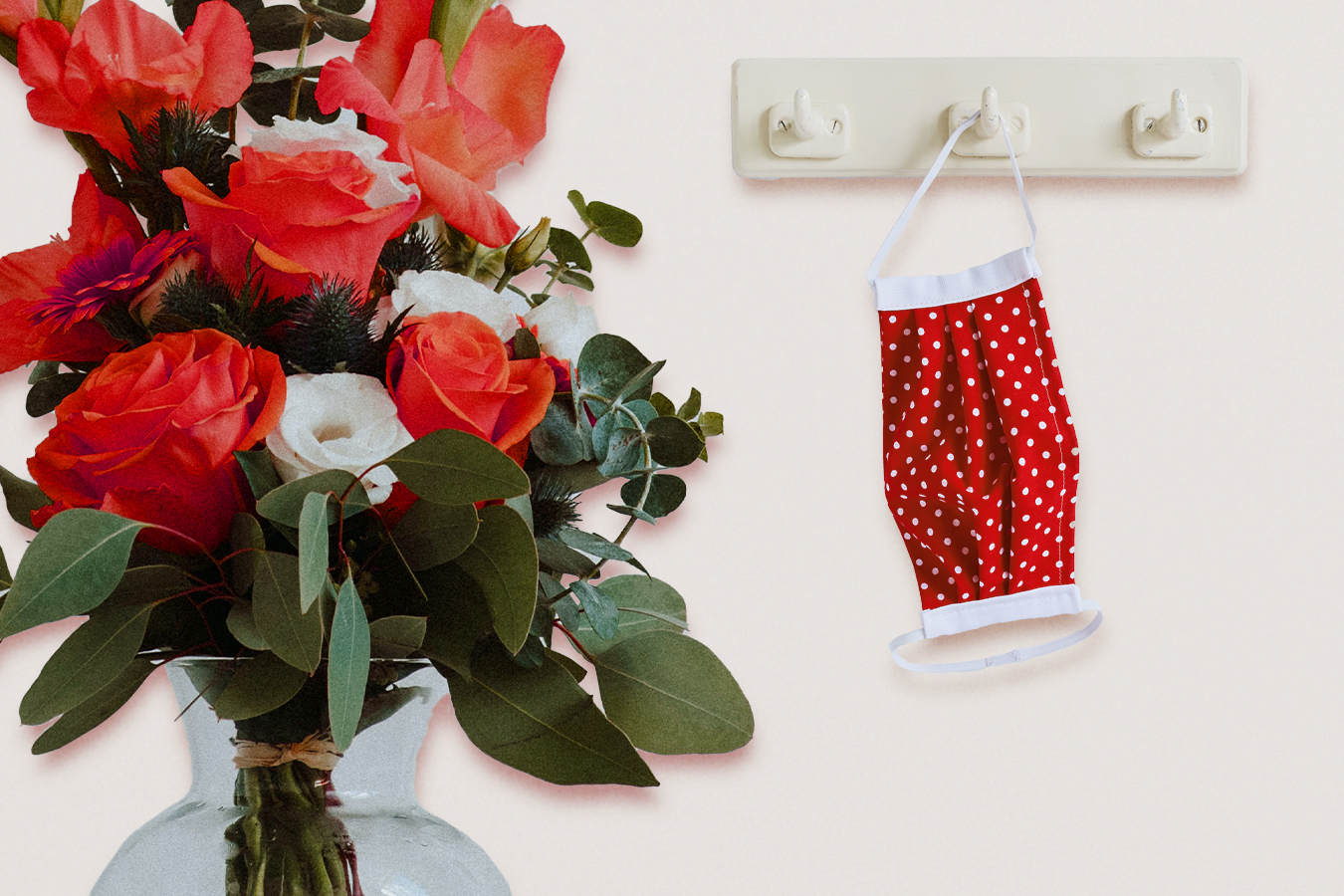 A vase of roses and a cloth mask.