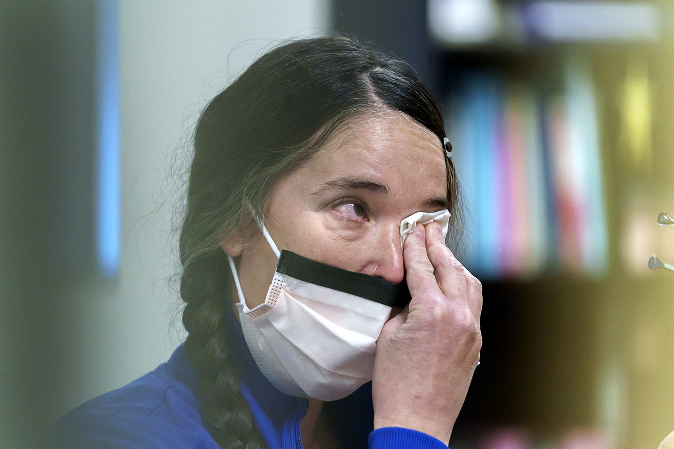 Close-up of a woman wiping tears from her eyes