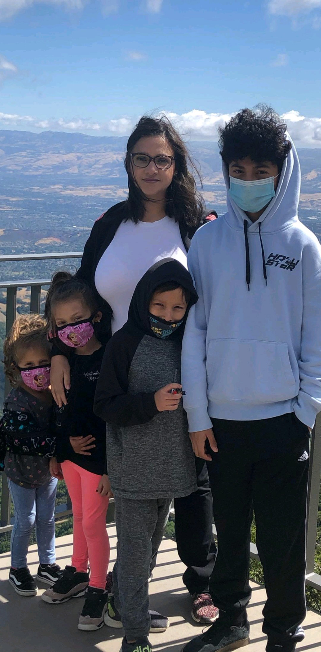 Maria Aguilar stands alongside her four children.