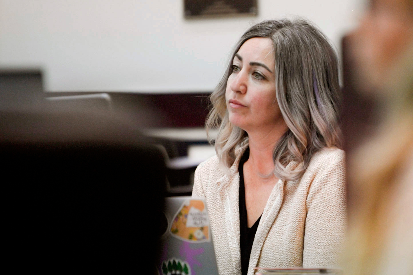 RaDonda Vaught is seen sitting in a courtroom. She looks to the left at something out of frame.