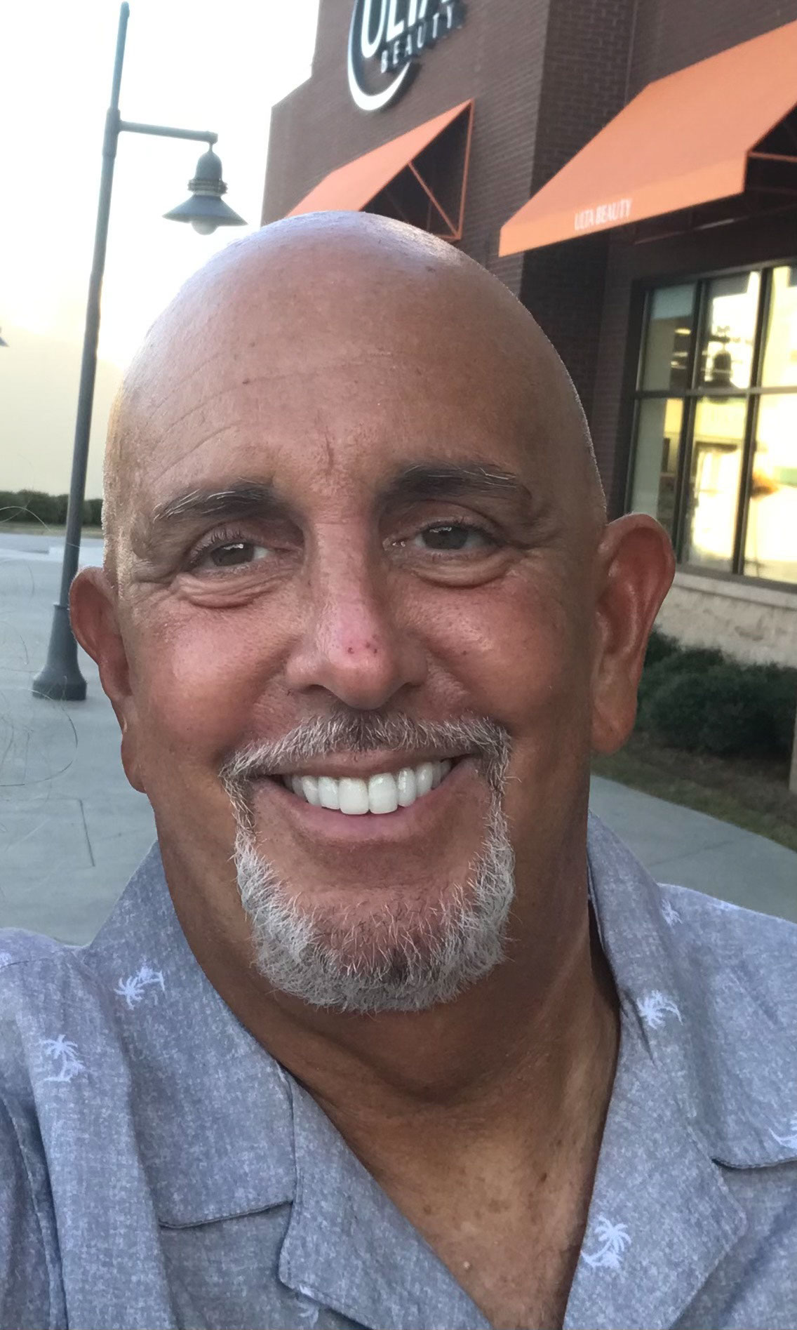 Jay Reinstein poses for a selfie, smiling at the camera.