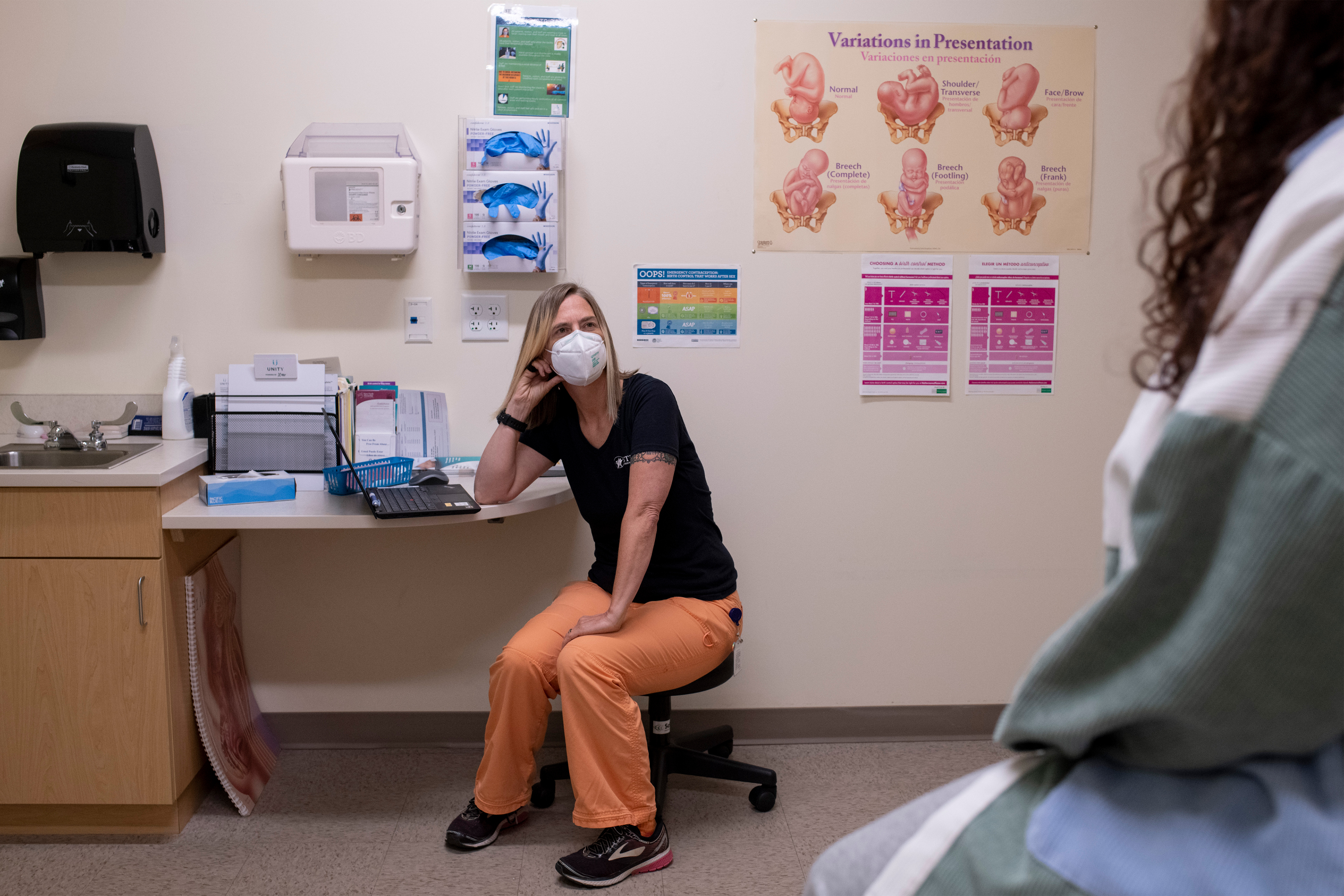 Shaunti Meyer is seen sititng in an exam room talking to someone out of frame.