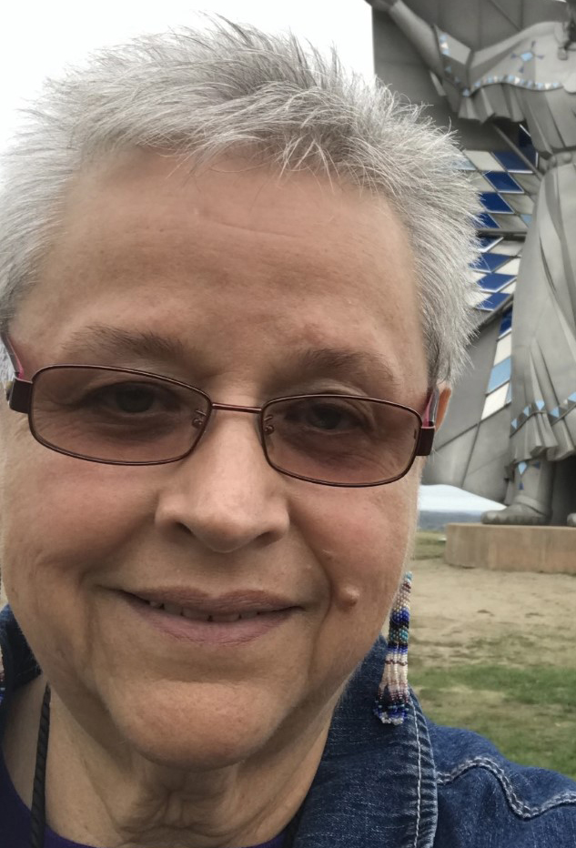 Charon Asetoyer poses for a selfie outside.